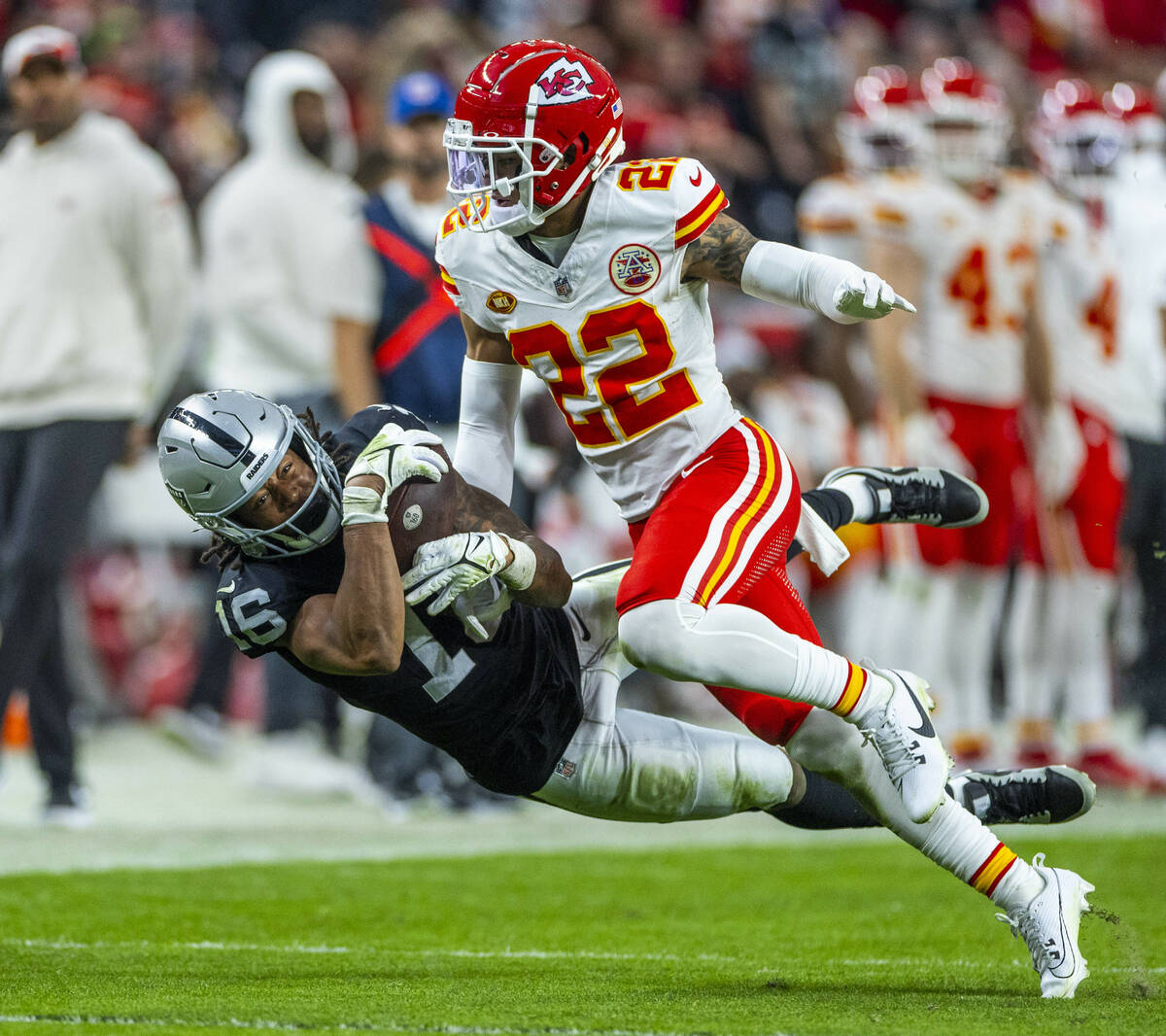 Raiders wide receiver Jakobi Meyers (16) hangs on to a long reception under tight coverage by K ...