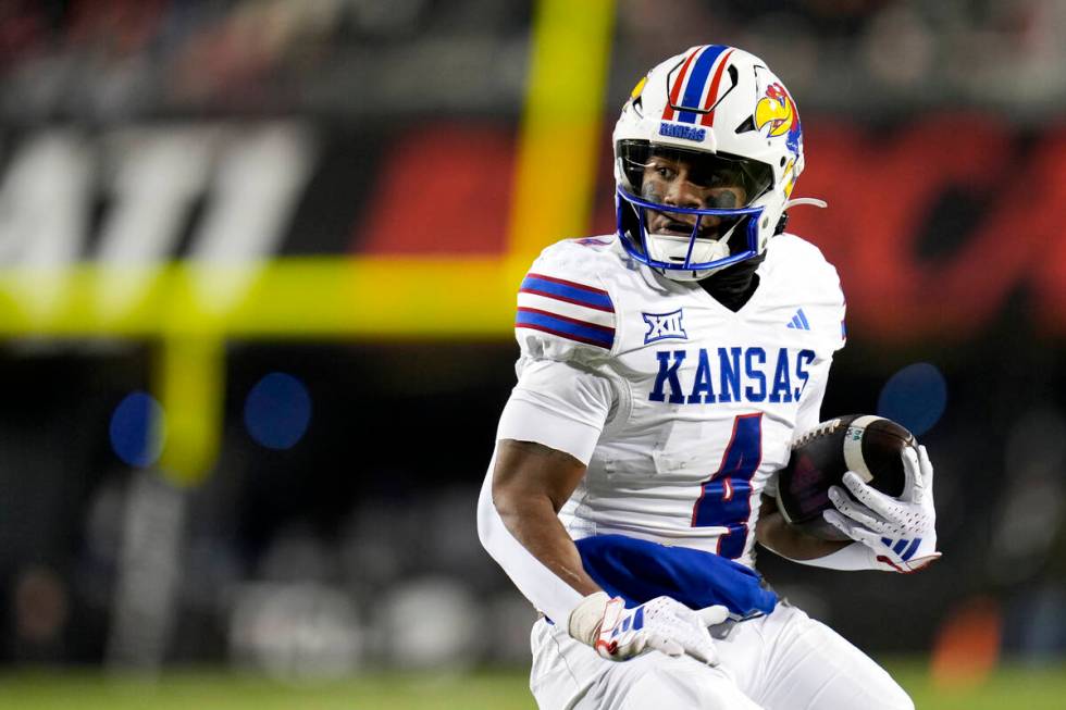 Kansas running back Devin Neal scores a touchdown against Kansas during an NCAA college footbal ...