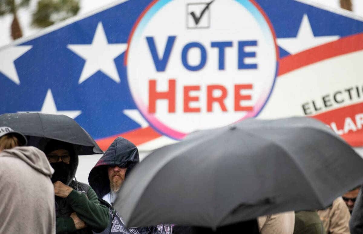 People wait in line to cast their vote at the Centennial Center polling place in Las Vegas, Tue ...