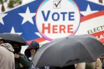 People wait in line to cast their vote at the Centennial Center polling place in Las Vegas, Tue ...