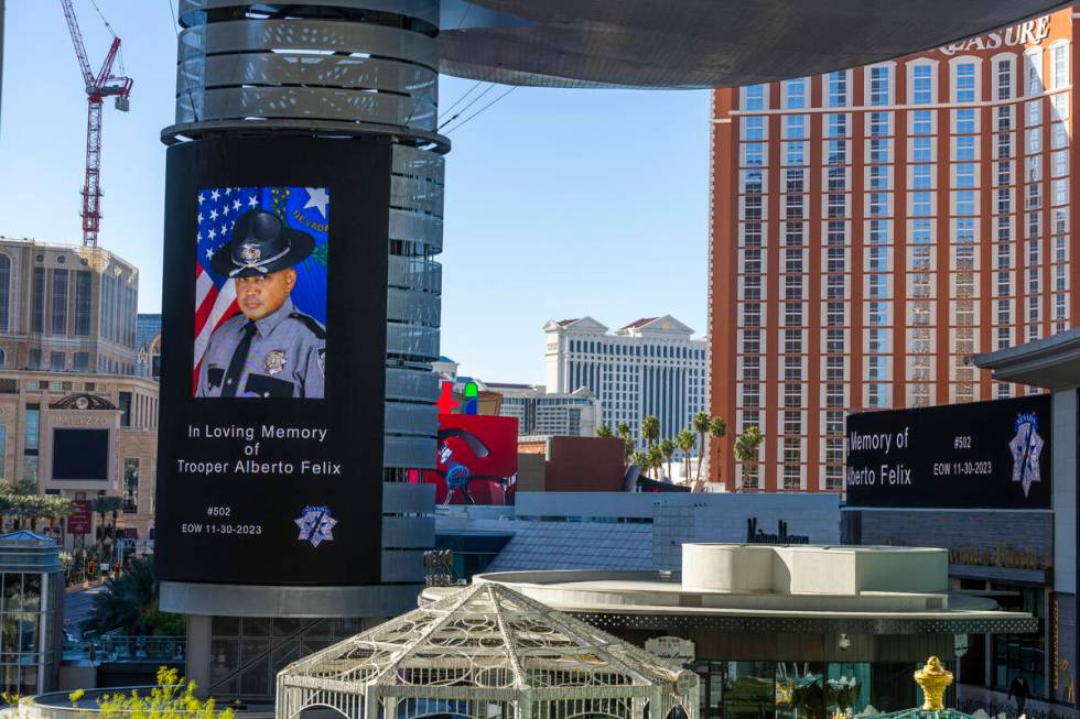A tribute to Nevada State Trooper Alberto Felix is projected on a video screen at Fashion Show ...