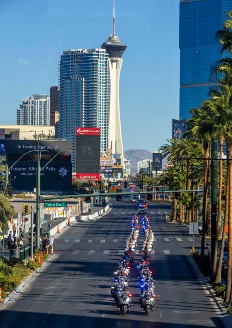 Police motorcycles lead a procession for Nevada State Trooper Alberto Felix down the Las Vegas ...