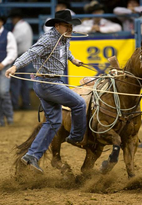 Cody Ohl of Hico, Texas, competes in calf roping during the sixth go-around of the National Fin ...
