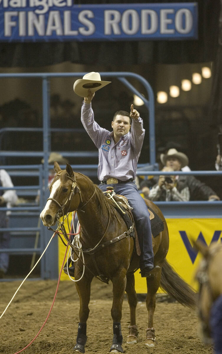 Professional calf roper Cody Ohl of Hico, Texas, waves to the crowd after tying for first place ...