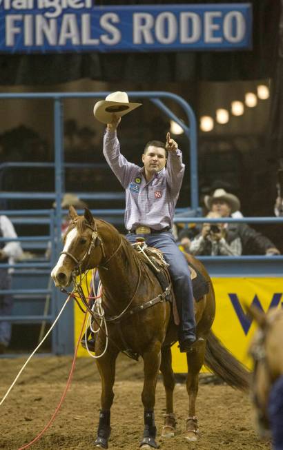 Professional calf roper Cody Ohl of Hico, Texas, waves to the crowd after tying for first place ...