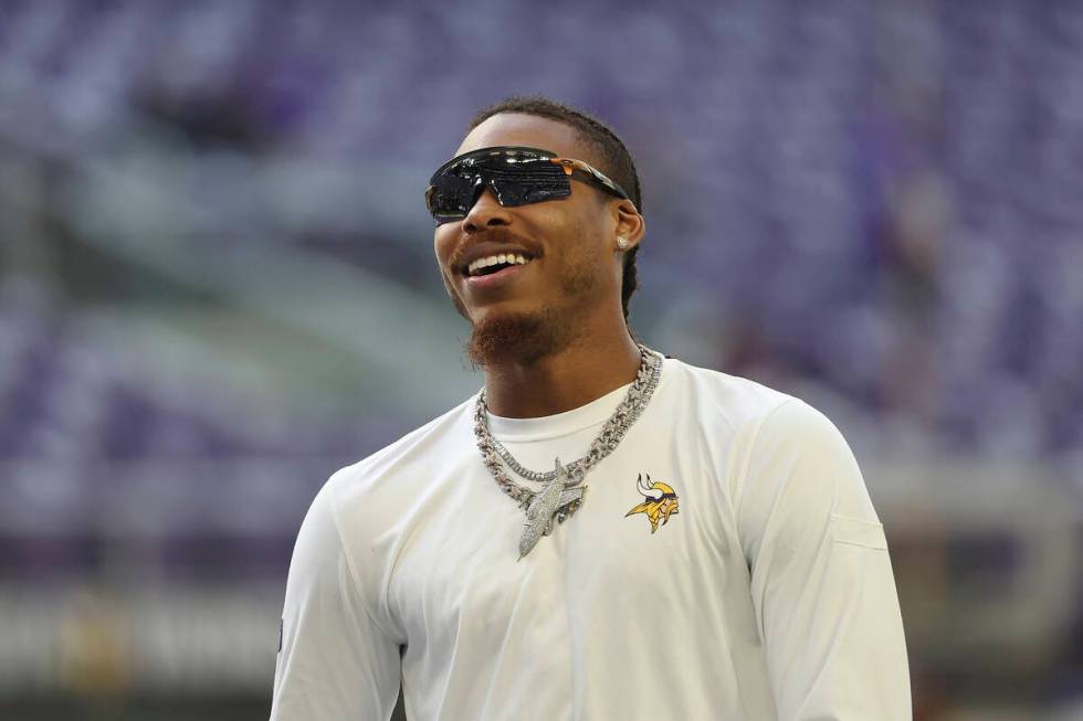 Minnesota Vikings wide receiver Justin Jefferson walks on the field before an NFL football game ...