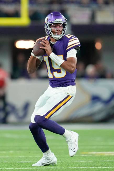 Minnesota Vikings quarterback Joshua Dobbs (15) looks to pass during the first half of an NFL f ...