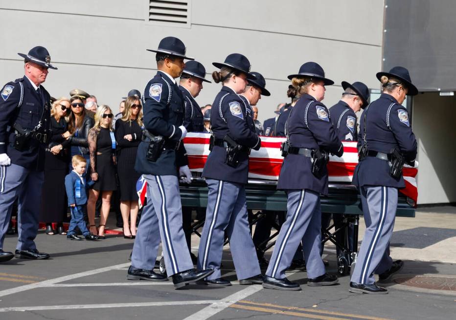 Vanessa Abbate, holding her 3-year-old son Vince, watches as members of the Honor Guard move th ...