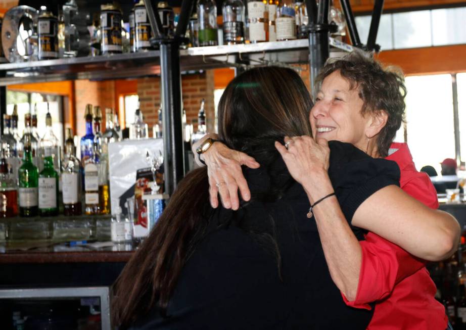 Bartender Andy Wolf, right, receives a hug from former colleague Rena von Duering of Las Vegas ...