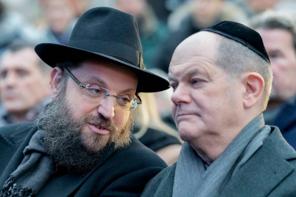 German Chancellor Olaf Scholz, right, and Rabbi Yehuda Teichtal attend the ceremony to light th ...