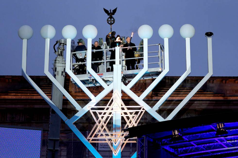 German Chancellor Olaf Scholz, right, and Rabbi Yehuda Teichtal attend the ceremony to light th ...