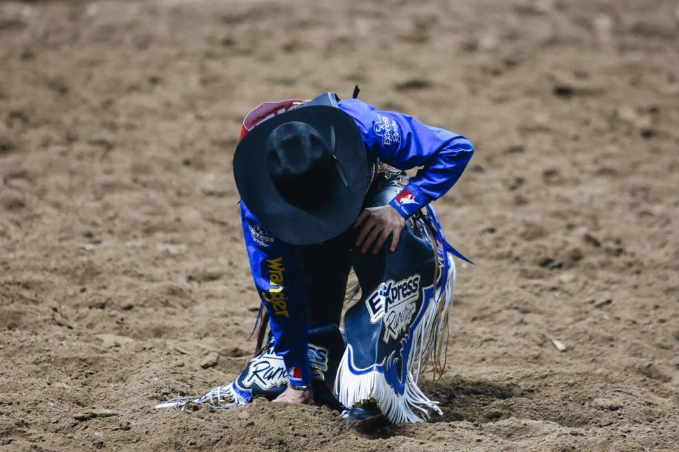 Ryder Wright gets up after getting bucked off of Trump Card during the National Finals Rodeo at ...