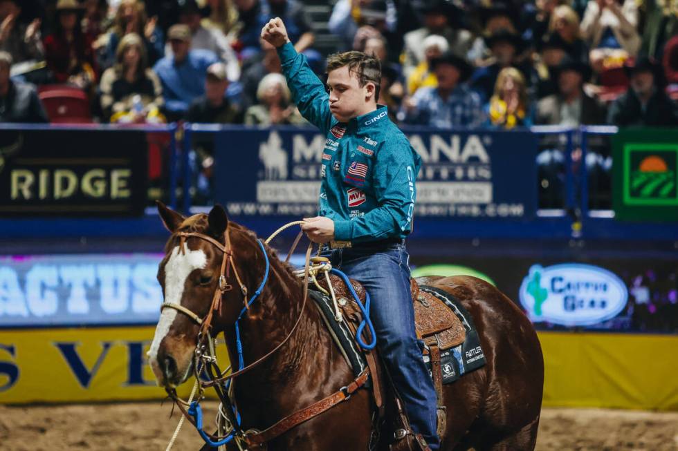 Riley Webb celebrates his time during the tie down roping portion of day three of the National ...