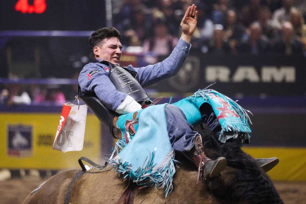 Reining world champion, Jess Pope, holds on to his horse while he competes in bareback riding o ...