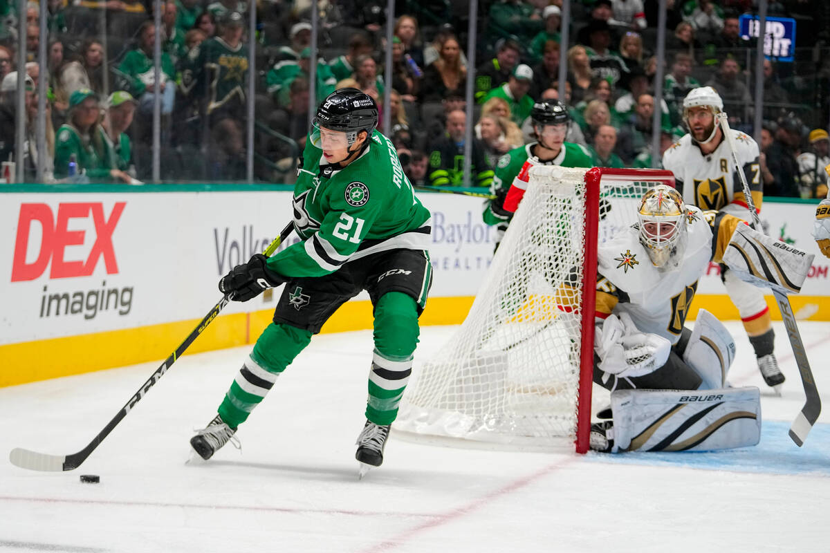 Dallas Stars left wing Jason Robertson (21) skates with the puck as Vegas Golden Knights goalte ...