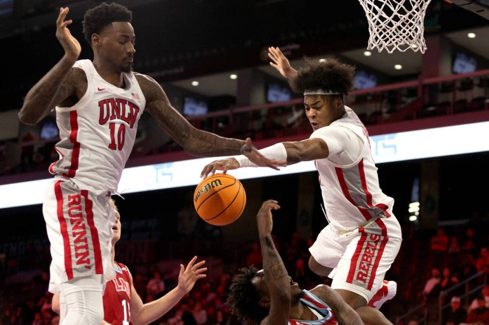 UNLV Rebels forward Kalib Boone (10) and forward Rob Whaley Jr. (5) deny a shot by the Loyola ...