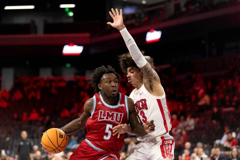 Loyola Marymount Lions guard Justin Wright (5) drives around against UNLV Rebels guard Brooklyn ...