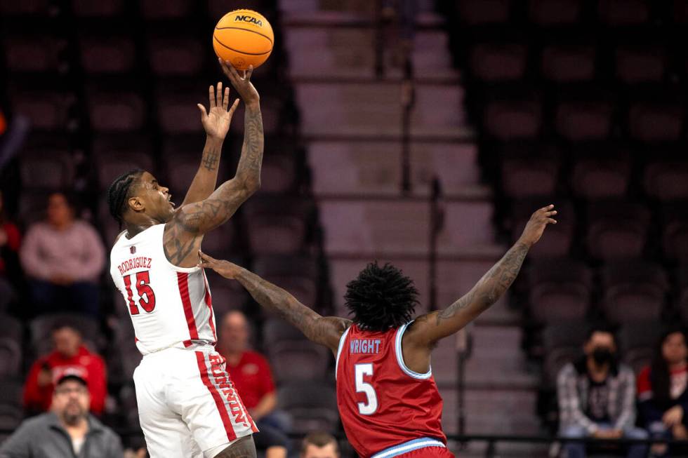 UNLV Rebels guard Luis Rodriguez (15) shoots against Loyola Marymount Lions guard Justin Wright ...