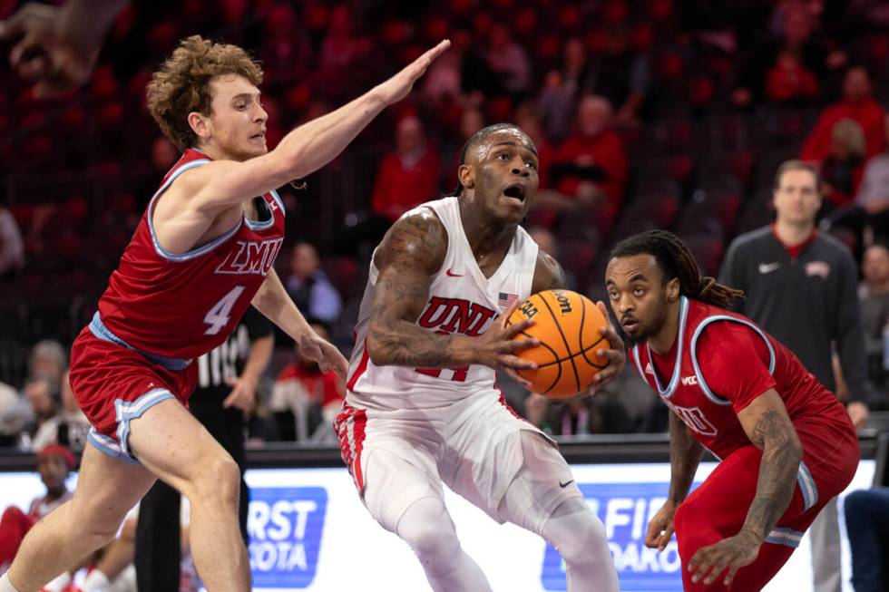 UNLV Rebels guard Jackie Johnson III (24) drives toward the hoop against Loyola Marymount Lions ...