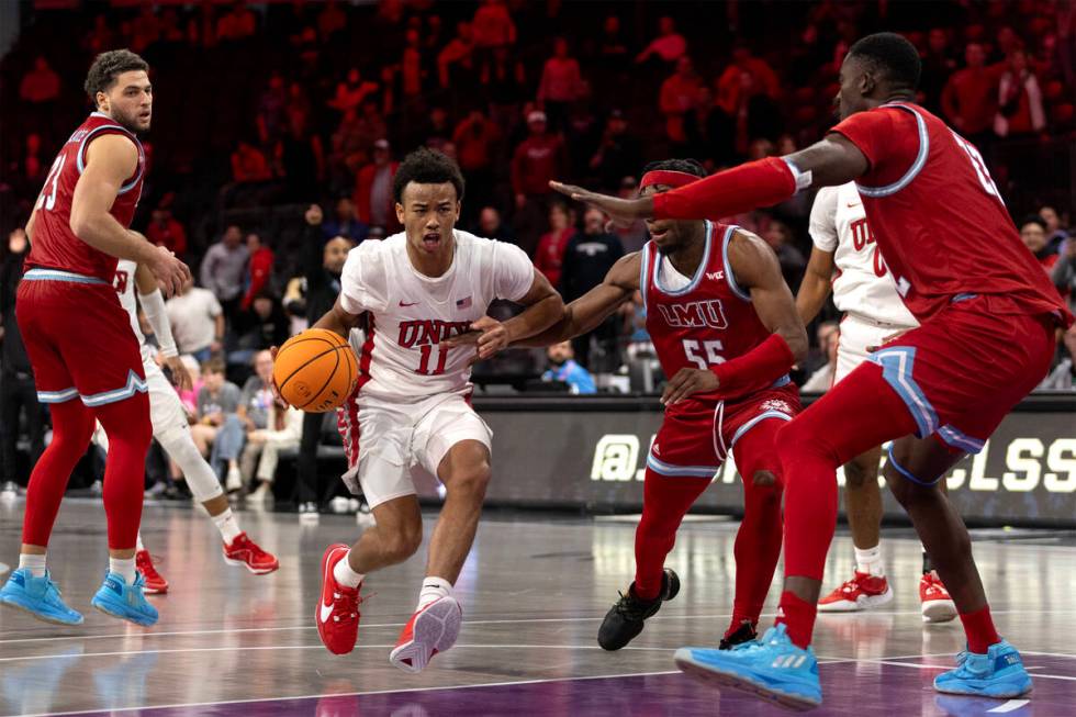 UNLV Rebels guard Dedan Thomas Jr. (11) drives toward the hoop against Loyola Marymount Lions g ...