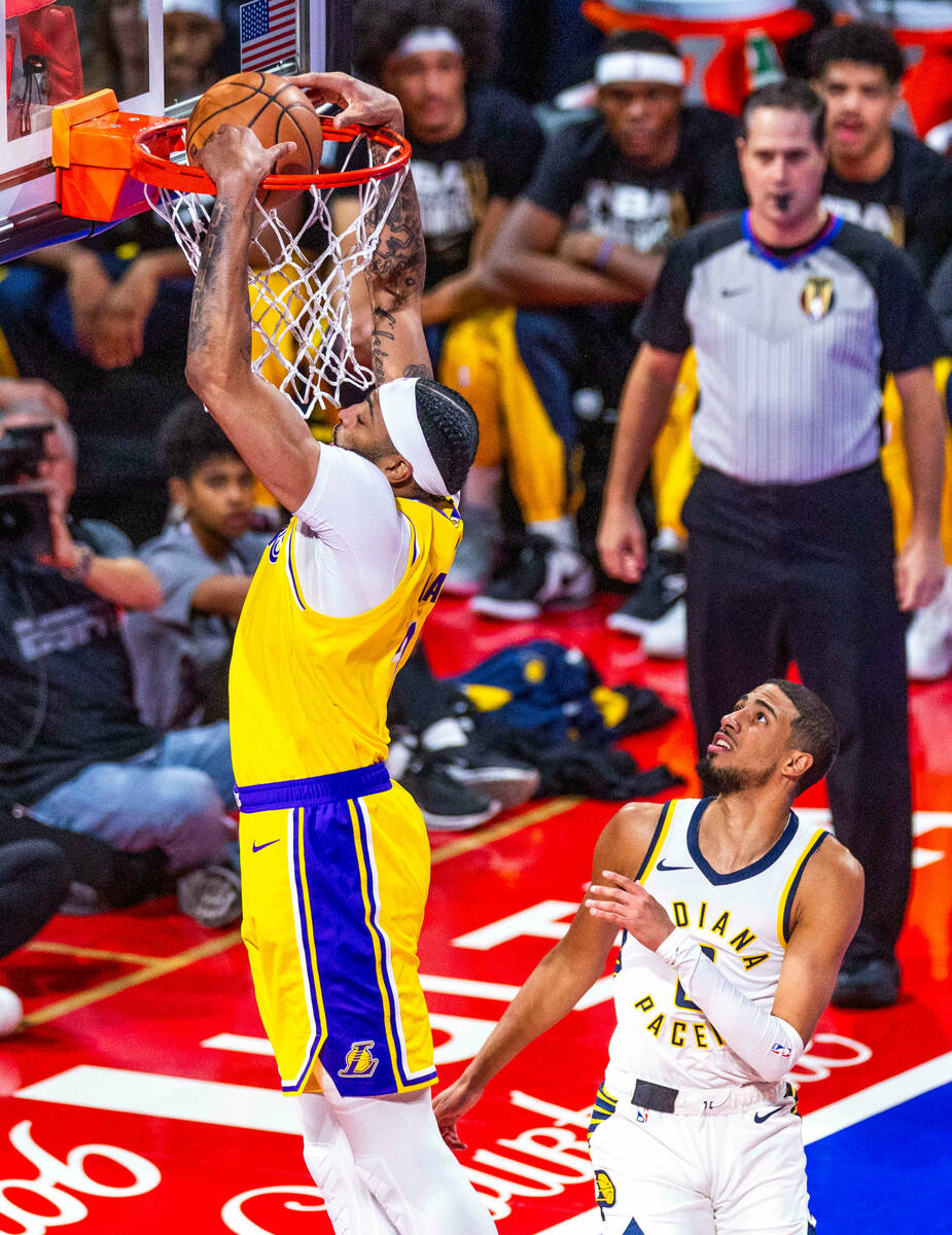 Los Angeles Lakers forward Anthony Davis (3) dunks the ball over Indiana Pacers guard Tyrese Ha ...