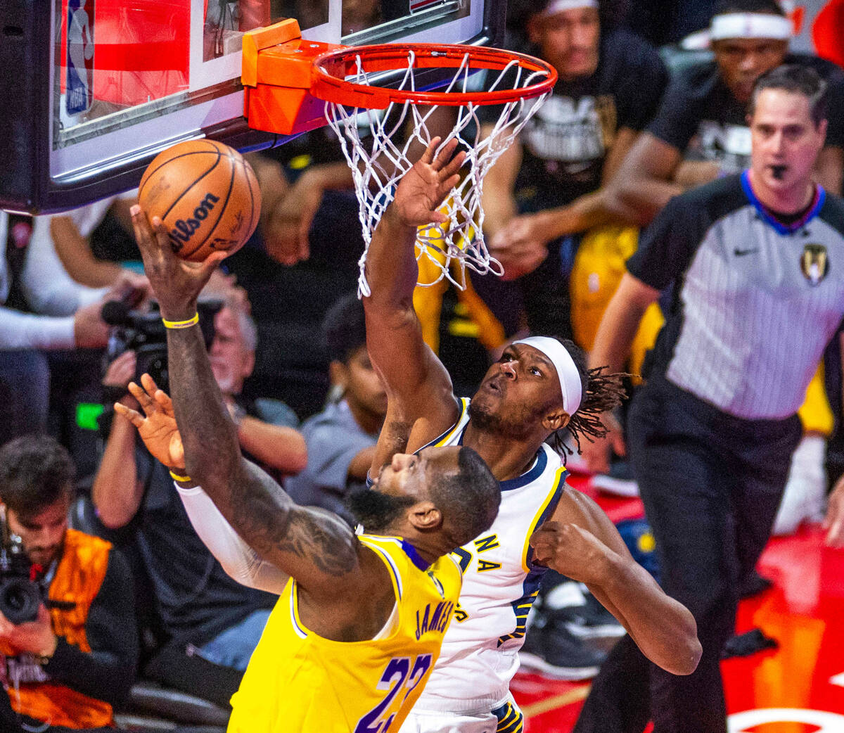 Los Angeles Lakers forward LeBron James (23) lays the ball in against Indiana Pacers forward Is ...