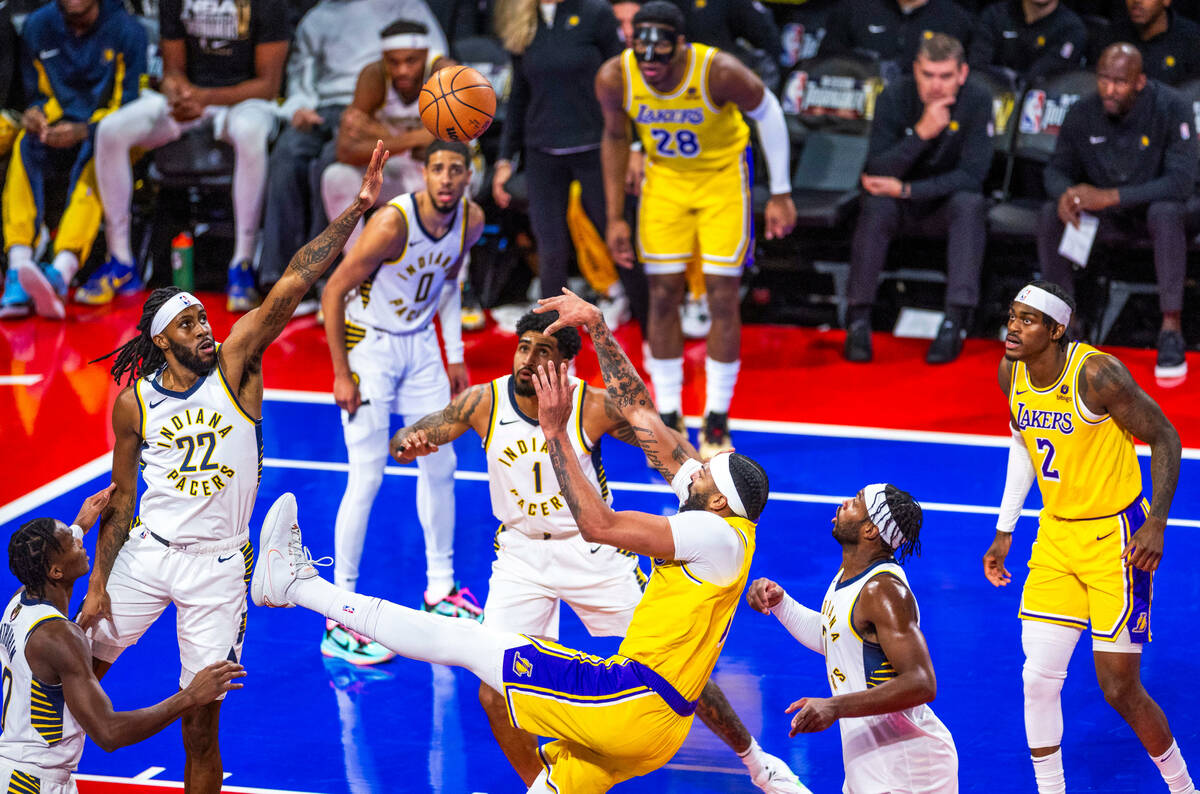 Los Angeles Lakers forward Anthony Davis (3) shoots while falling backwards against the Indiana ...