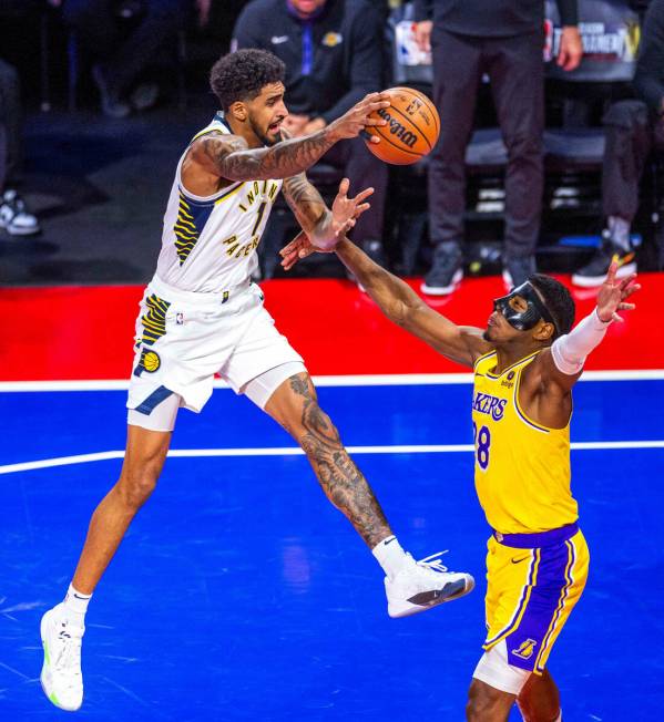 Indiana Pacers forward Obi Toppin (1) looks to pass over Los Angeles Lakers forward Rui Hachimu ...