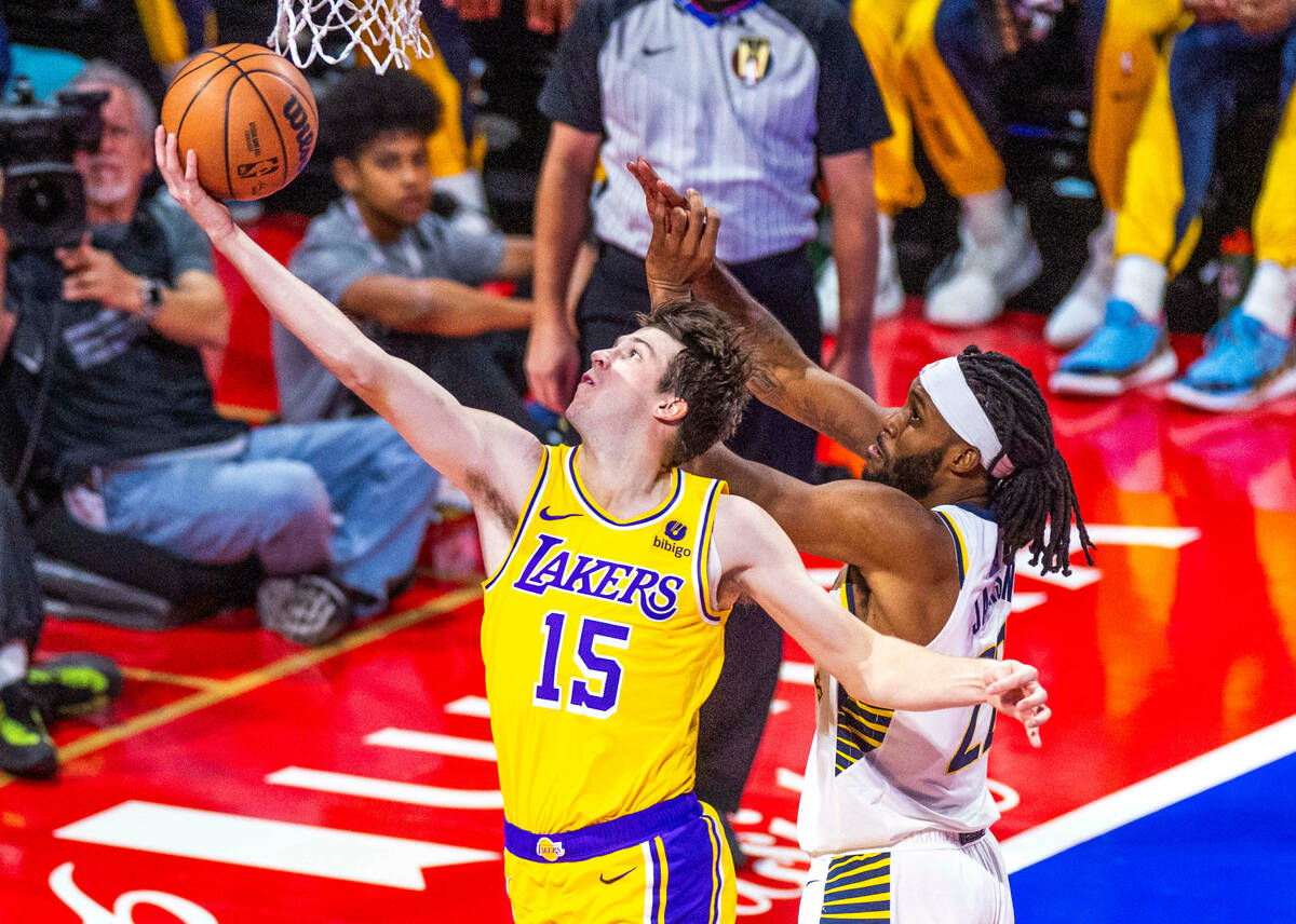 Los Angeles Lakers guard Austin Reaves (15) lays in na shot against Indiana Pacers forward Isai ...