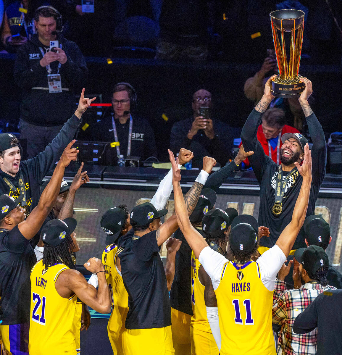 Los Angeles Lakers forward Anthony Davis (3) holds up the winning trophy about teammates after ...