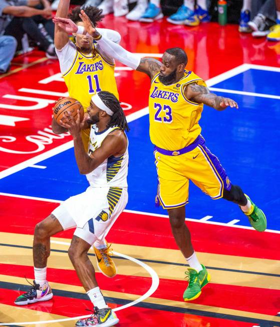 Indiana Pacers guard Buddy Hield (7) looks to shoot as Los Angeles Lakers center Jaxson Hayes ( ...