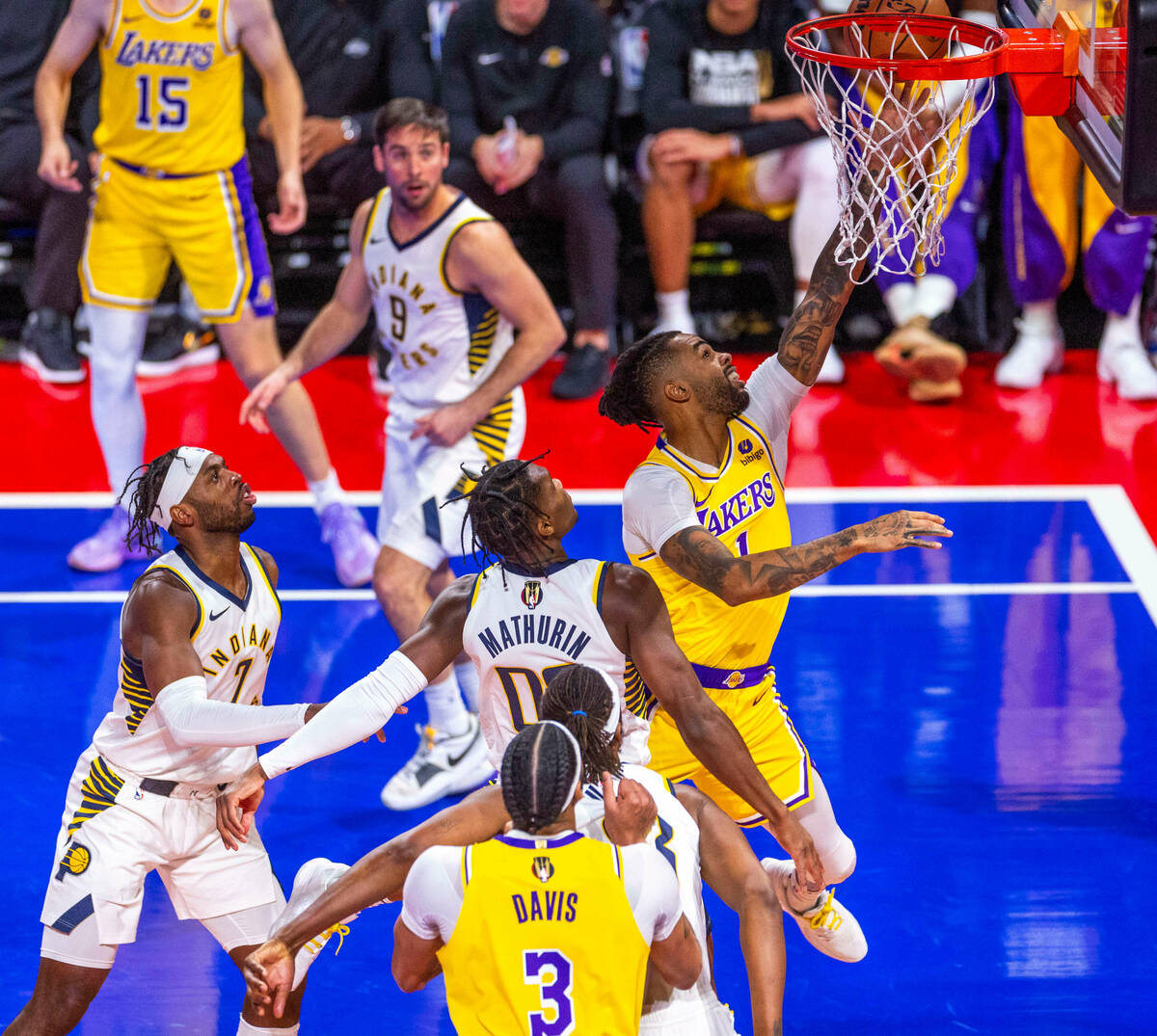 Los Angeles Lakers guard D'Angelo Russell (1) gets to the basket past Indiana Pacers guard Benn ...