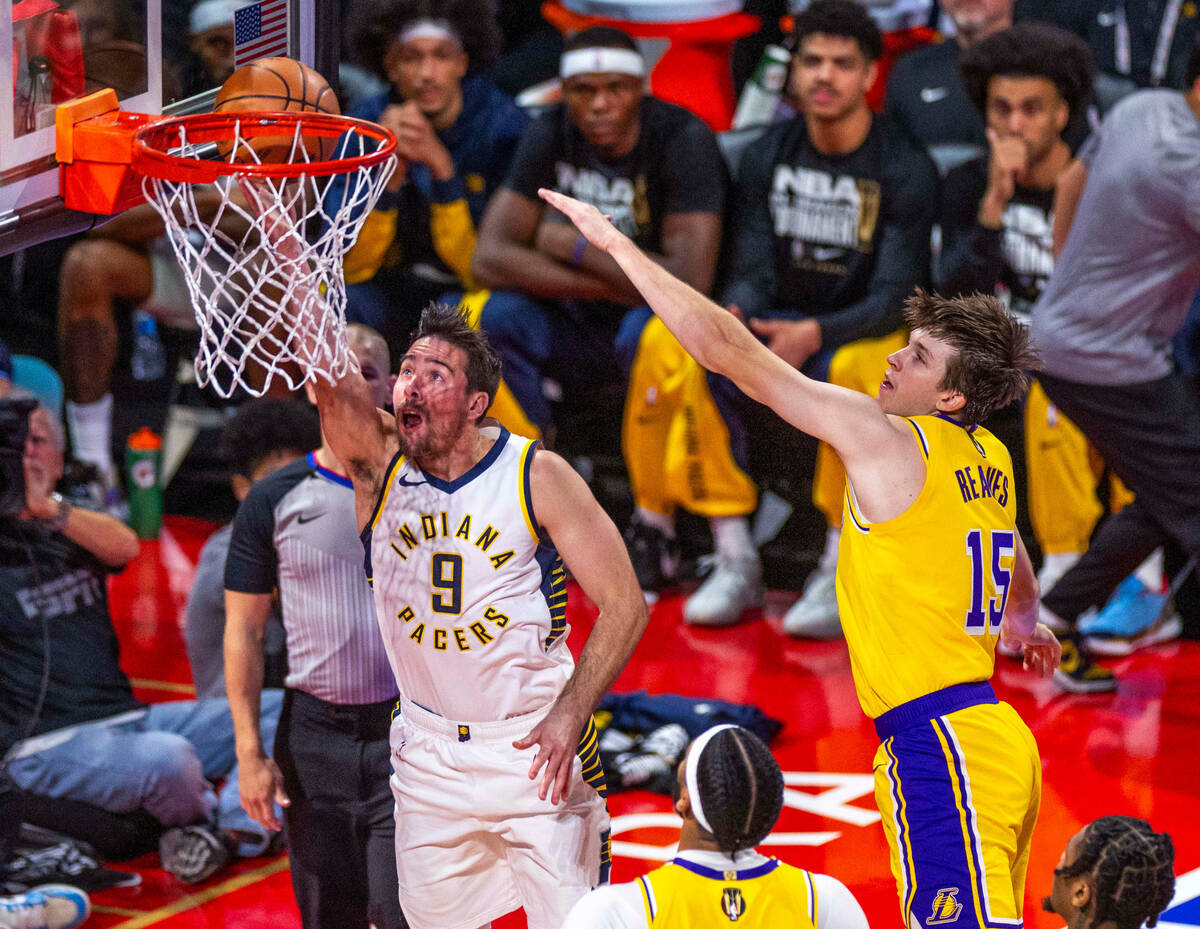 Indiana Pacers guard T.J. McConnell (9) scores past Los Angeles Lakers guard Austin Reaves (15) ...