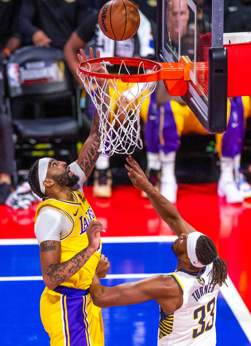 Los Angeles Lakers forward Anthony Davis (3) taps the ball in over Indiana Pacers center Myles ...