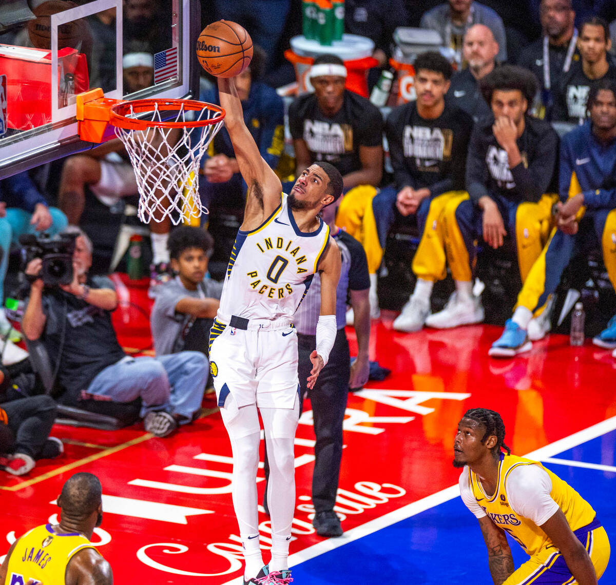 Indiana Pacers guard Tyrese Haliburton (0) scores as Los Angeles Lakers forward Cam Reddish (5) ...