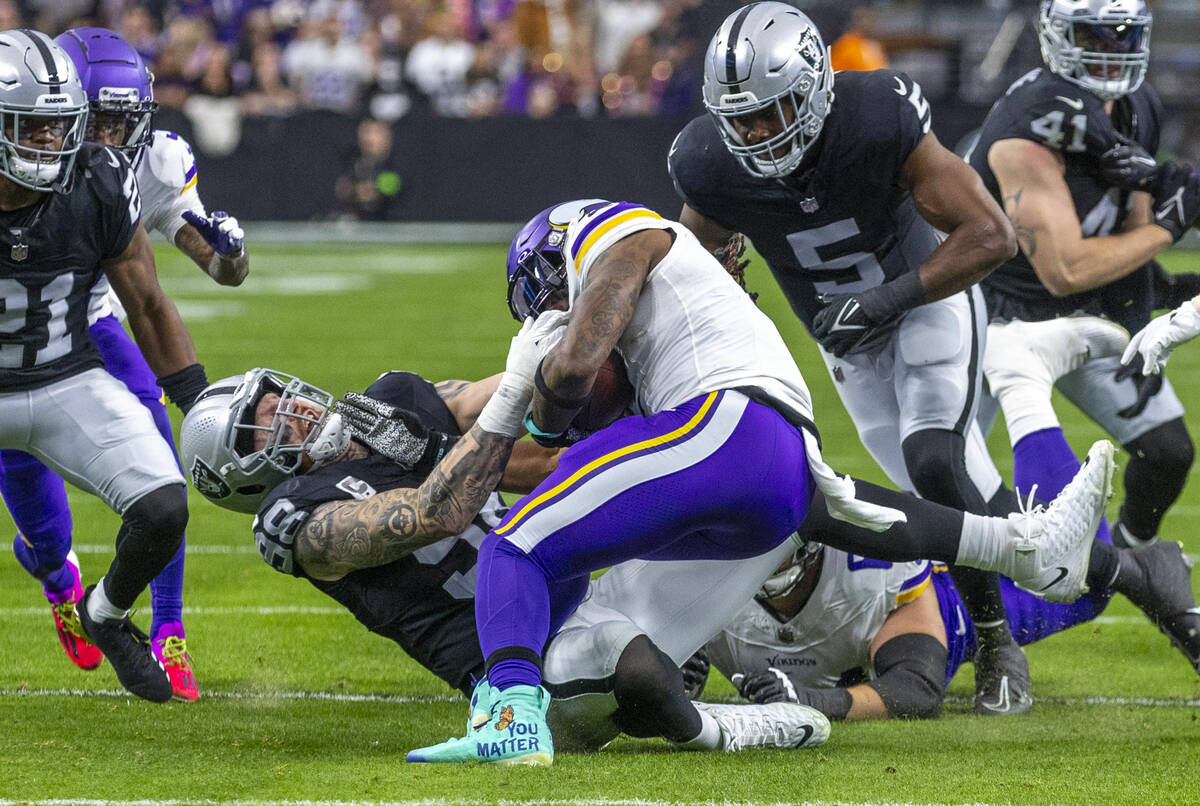 Raiders defensive end Maxx Crosby (98) stops Minnesota Vikings running back Alexander Mattison ...