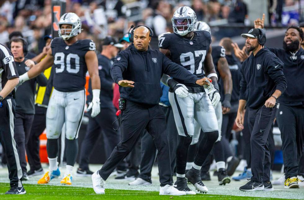 Raiders interim head coach Antonio Pierce signals his intentions on a penalty by the Minnesota ...