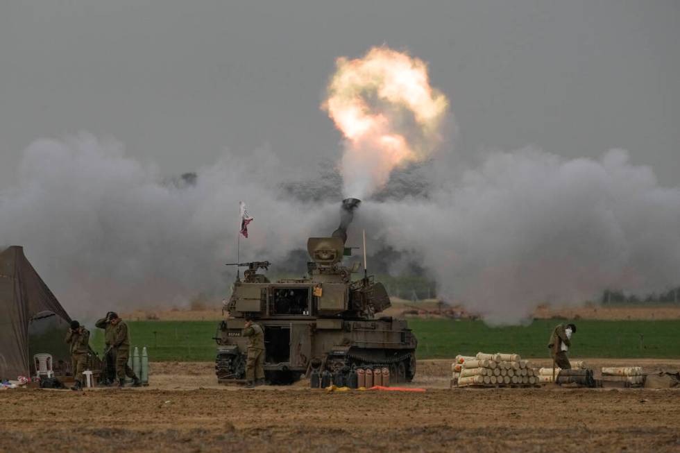 An Israeli mobile artillery unit fires a shell from southern Israel towards the Gaza Strip, in ...