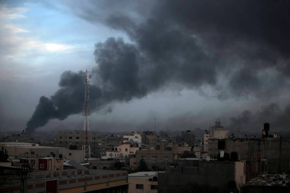 Smoke rises from town of Khan Younis after Israeli strikes on Sunday, Dec. 10, 2023. (AP Photo/ ...