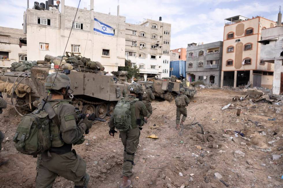 Israeli soldiers take part in a ground operation in Gaza City's Shijaiyah neighborhood, Friday, ...