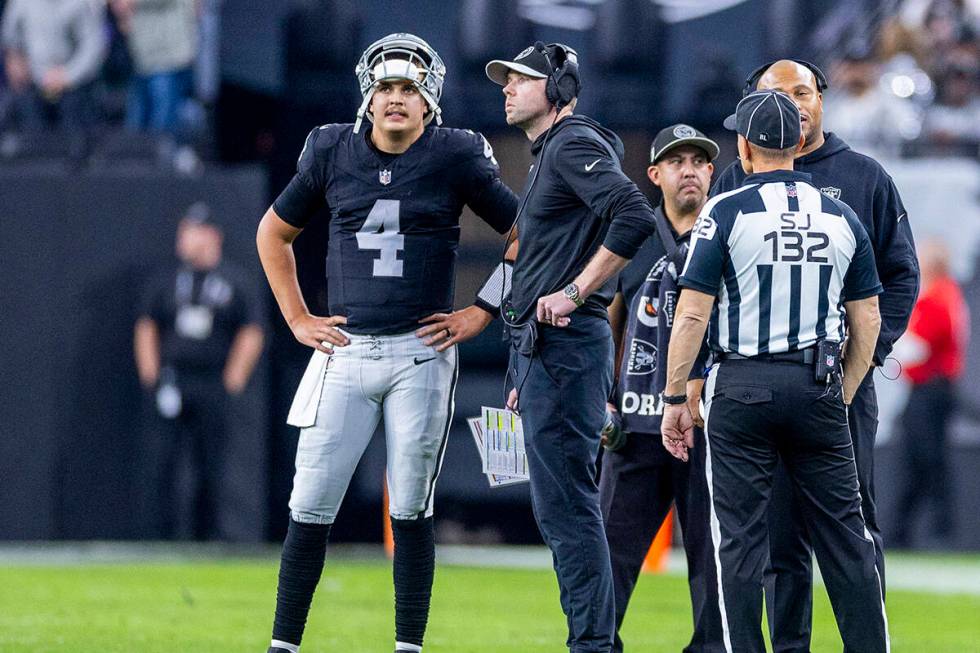 Raiders quarterback Aidan O'Connell (4) stands with Offensive Coordinator Bo Hardegree on the f ...