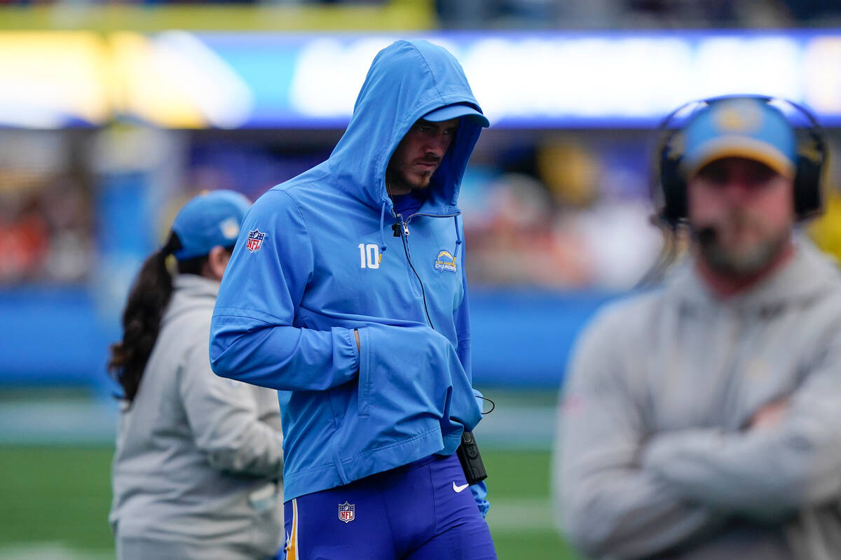 Los Angeles Chargers quarterback Justin Herbert walks on the sidelines after an injury with his ...