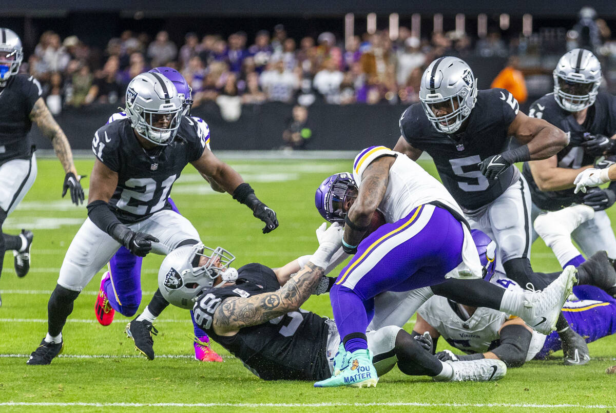 Raiders defensive end Maxx Crosby (98) pulls down Minnesota Vikings running back Alexander Matt ...