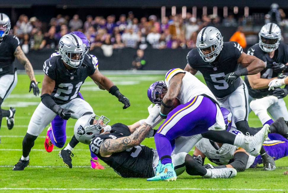 Raiders defensive end Maxx Crosby (98) pulls down Minnesota Vikings running back Alexander Matt ...