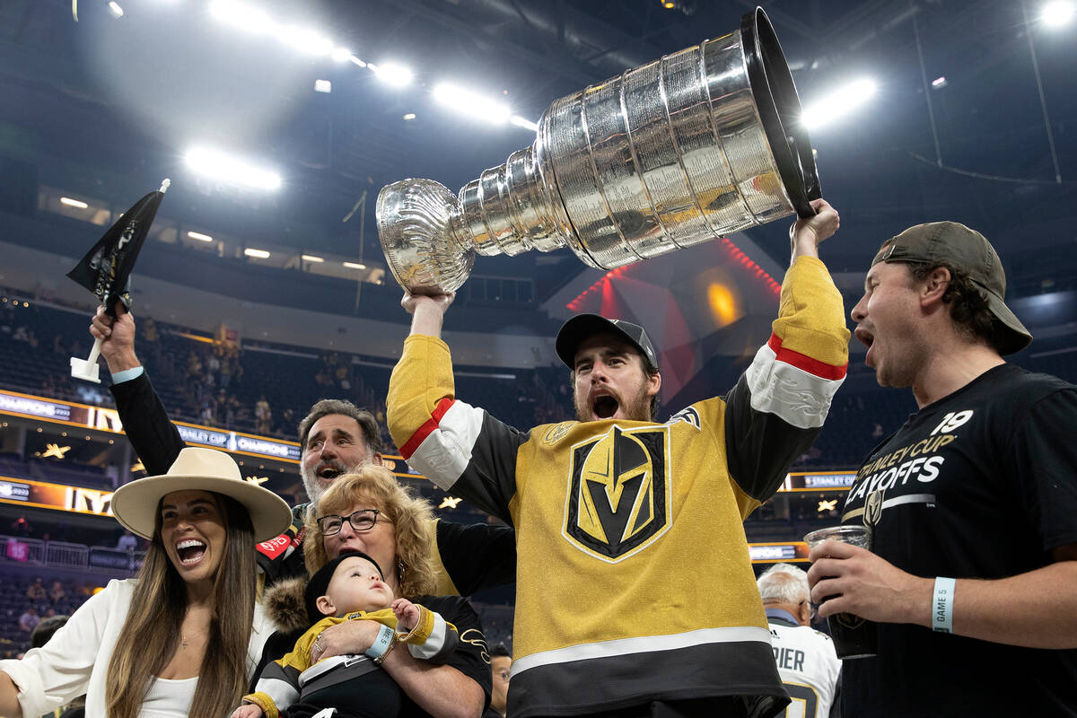 Golden Knights right wing Reilly Smith (19) poses with his family and the Stanley Cup after the ...