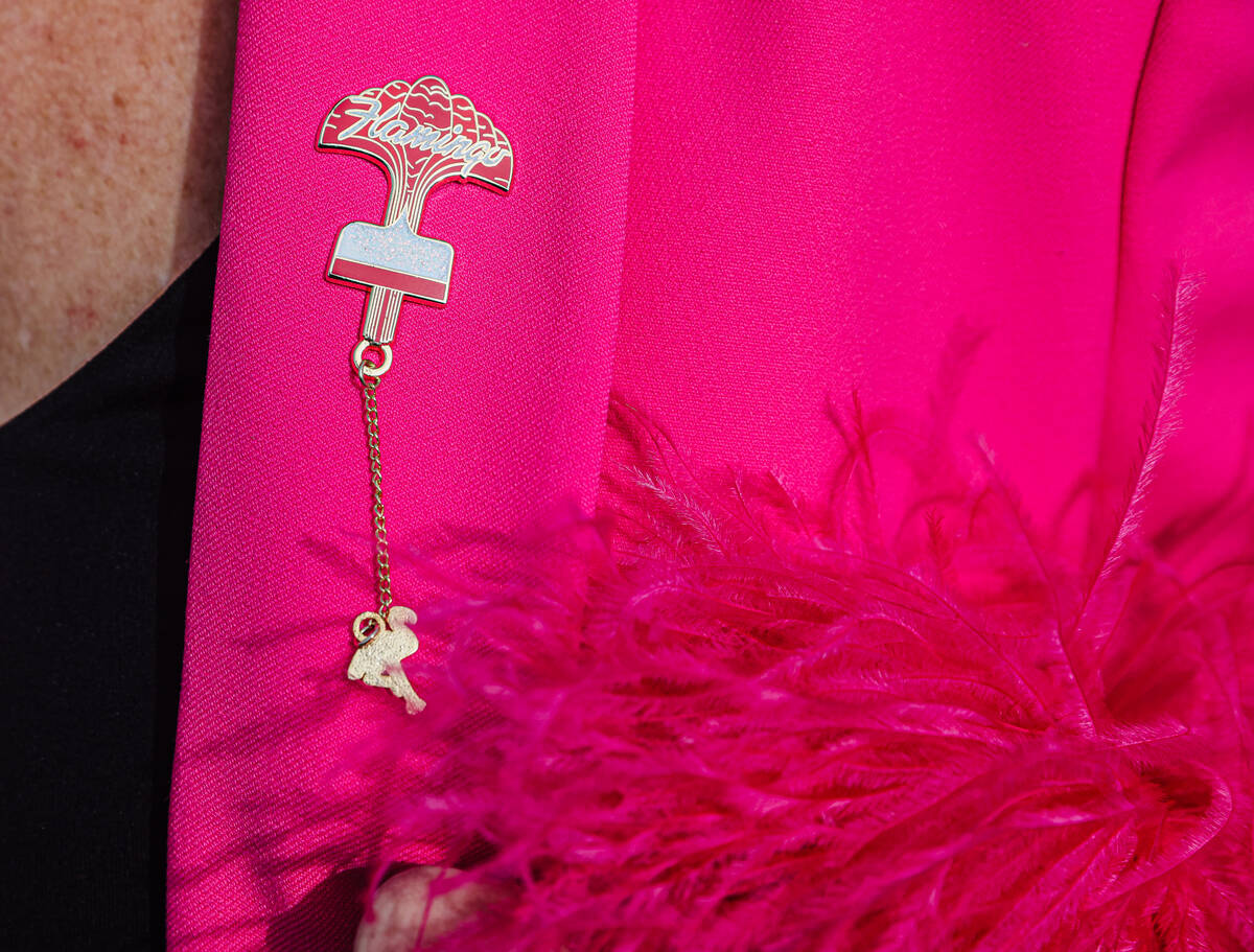 Donor Emily Conner Cooper shows off a Flamingo pin in the Neon Boneyard of the Neon Museum in L ...