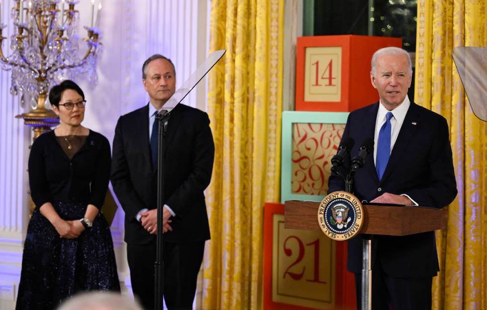 President Joe Biden speaks at a Hanukkah reception in the East Room of the White House in Washi ...