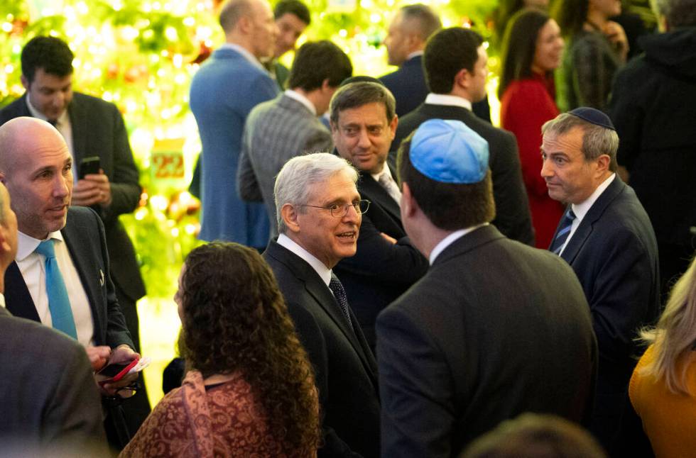 Attorney General Merrick Garland speaks to a guest at a Hanukkah reception with President Joe B ...