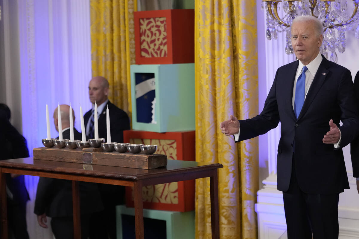 President Joe Biden arrives to speak at a Hanukkah reception in the East Room of the White Hous ...