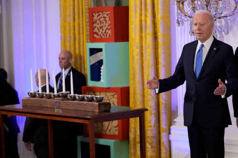 President Joe Biden arrives to speak at a Hanukkah reception in the East Room of the White Hous ...